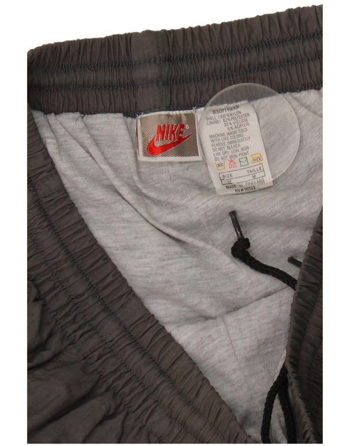 Pantaloni da tuta da uomo Nike Joggers in nylon grigio medio
