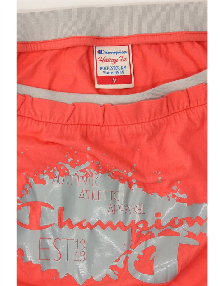 Tuta corta da donna con spalle scoperte con grafica Champion UK 12 arancione medio