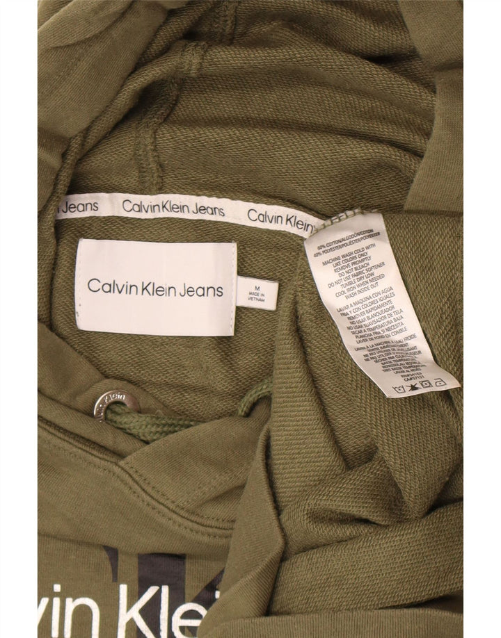 Calvin Klein Jeans Maglia con cappuccio grafica lunga da donna UK 12 Medio Cachi