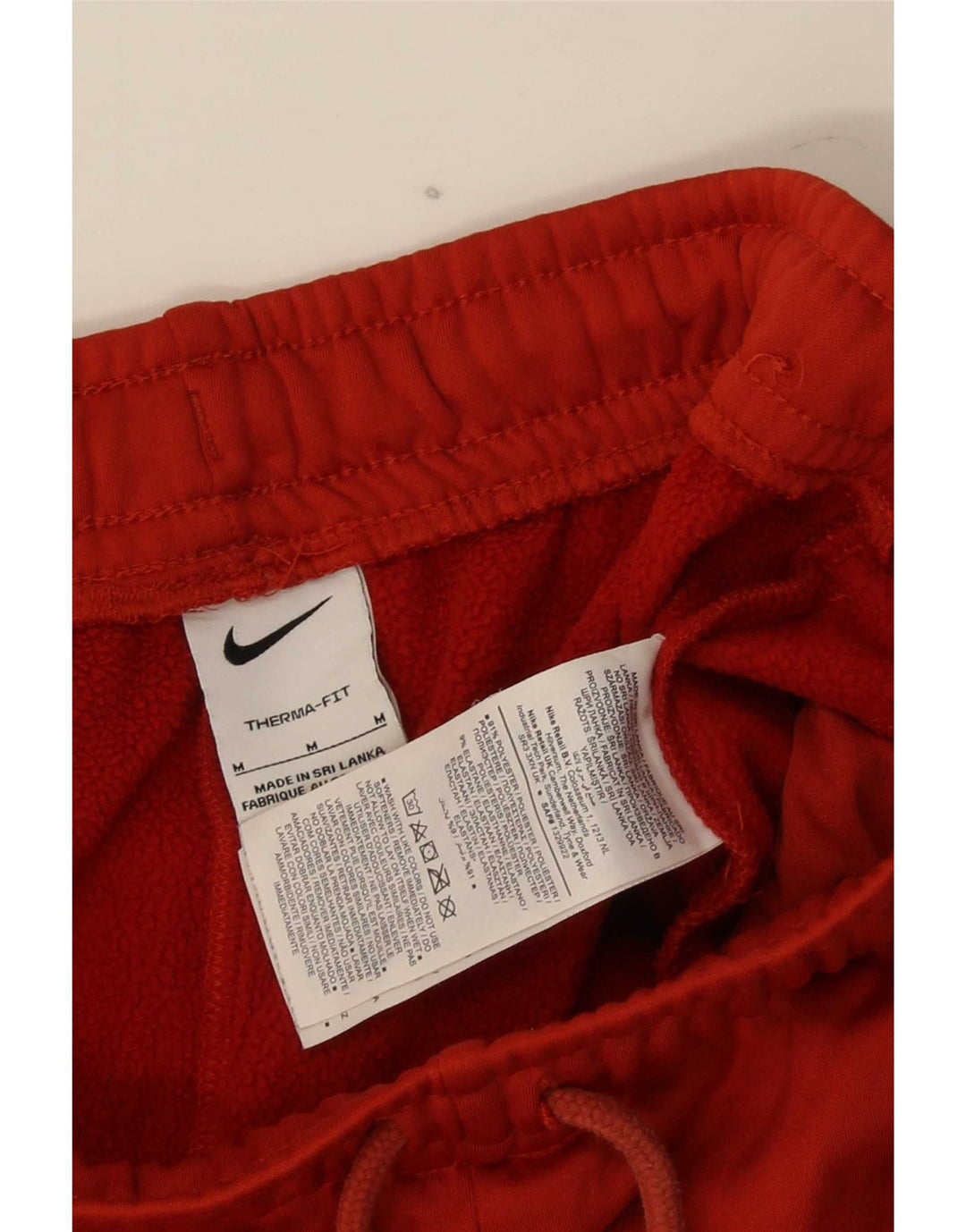 Pantaloni da tuta grafica Nike Therma-Fit da uomo in poliestere rosso medio