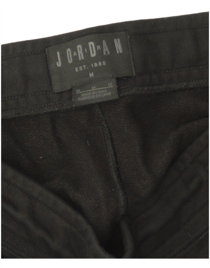Pantaloni da tuta con grafica Jordan Paris Saint-Germain da uomo di colore nero medio